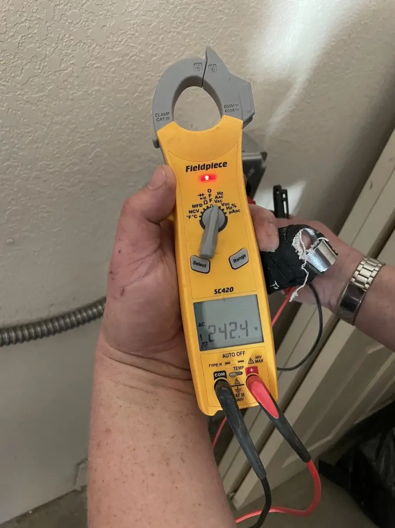Voltage testing with clamp meter during Outlet Installation in Hesston